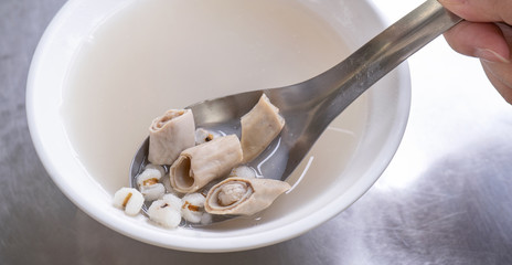 Four tonics soup, four ingredients herb flavor soup. Taiwanese delicious street food delicacy with Job's tears, pork intestines, close up, copy space