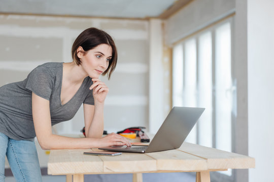 Young woman or decorator using a laptop