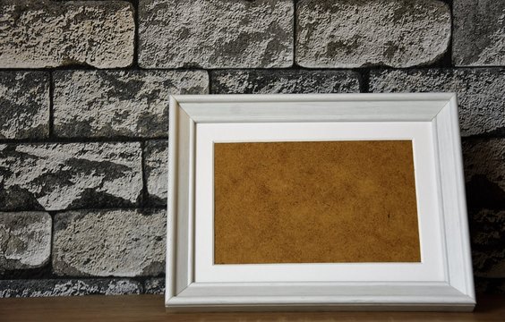 white wooden frame on gray brick wallpaper background