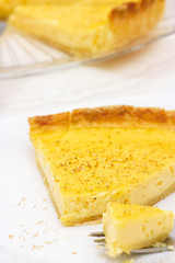 Sweet custard tart or lemon pie white background. Selective focus. Close up.