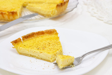 Sweet custard tart or lemon pie white background. Selective focus. Close up.