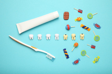 Teeth with sweet candies. Tooth caries in children's, dental healthcare, toothpaste and toothbrush.