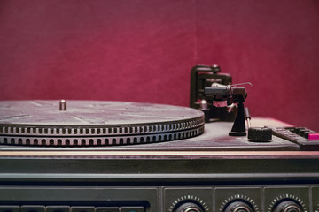 Fototapeta na wymiar Old record player on red background