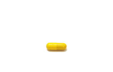 Medicine yellow pills on white background with copy space