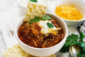 Homemade Chili bowl served with crackers, selective focus