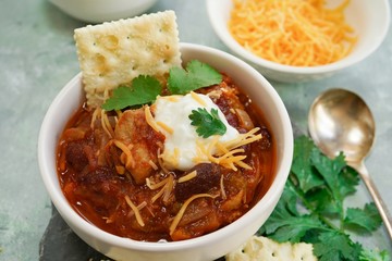 Homemade Chili bowl served with crackers, selective focus