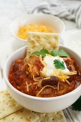 Homemade Chili bowl served with crackers, selective focus