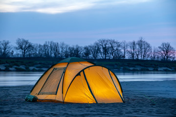 Tourist tent at the river at sunrise