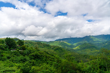 Fototapeta premium Blue sky high peak mountains fog hills mist scenery national park views at Phu Tub Berk, Khao Koh, Phetchabun Province, Thailand