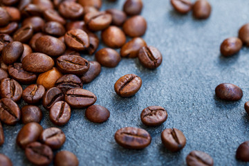 Coffee beans on grey slate background. Top view. Copy space.