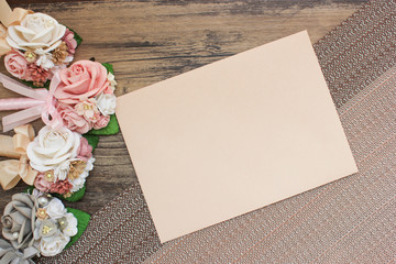 Pen decorated with flowers for wedding and envelope on wood table