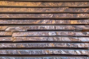 Stack of different size cut wood planks for construction