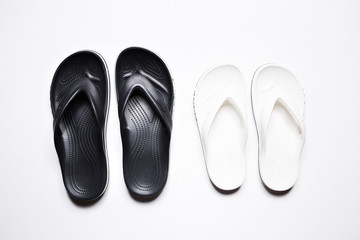 Flip Flops on a white isolated background. Black male and female white.