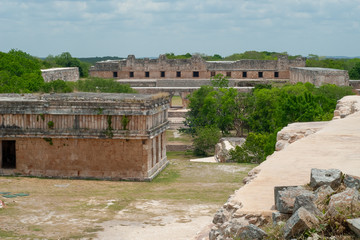 Fototapeta na wymiar Mayan ruins, with temples and dwellings, in the archaeological area of Uxmal, in the Mexican Yucatan peninsula