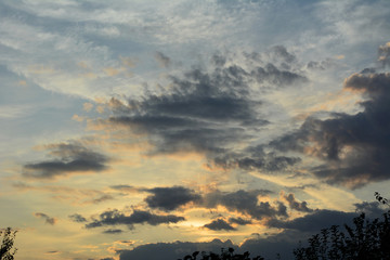 Sunset sky in the evening with light and dark clouds.
