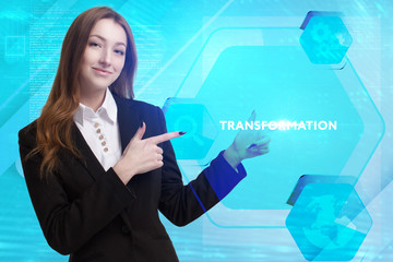 The concept of business, technology, the Internet and the network. A young entrepreneur working on a virtual screen of the future and sees the inscription: Transformation