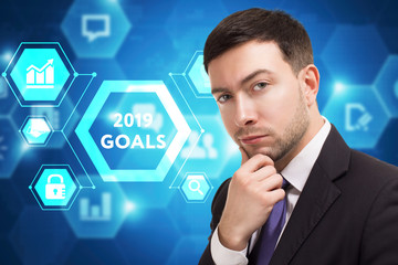 The concept of business, technology, the Internet and the network. A young entrepreneur working on a virtual screen of the future and sees the inscription: 2019 goals