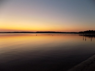 Fototapeta na wymiar Orange sunset glow over lagoon