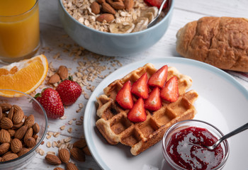 Oatmeal porridge and belgian waffle with fruit and nuts on white background. Morning delicious muesli, croissant. Food set.