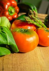 vertical photo of celery, asparagus and fresh tomatoes