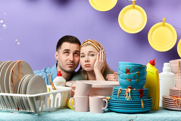 depressed puzzled young people don't know waht dishwashing liquid use for cleaning the kicthen and cutlery,