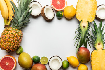 frame made of organic exotic fruits on white background with copy space