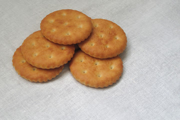 Crackers or bakery food laid on white fabric tablecloth. Bread or other baked goods image. Home...