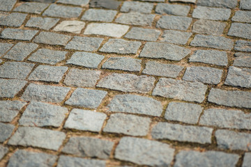 Brown square cobblestone pavement.Top view on the stone road close up.Layout or vintage grunge texture.