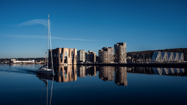 Landscape of buildings near the pier. Yacht on the background of new buildings