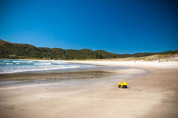 Fototapeta na wymiar Yellow toy truck on the beach