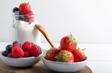 yogurt with fruit on a breakfast table on a white background