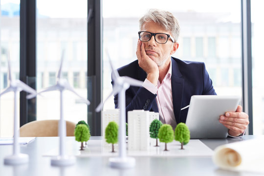 Tired businessman thinking about new solutions