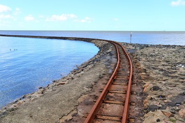Old rusty weathered railroads right at the baltic sea coast