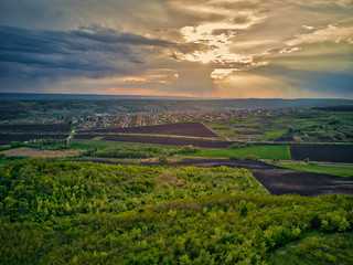 Fototapeta na wymiar Flight over cultivating field in the spring at sunset. Moldova Republic of.