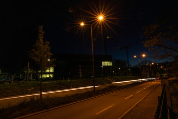 Fototapeta na wymiar Enlighted street near Campus FHNW Brugg Switzerland by night. No cars.