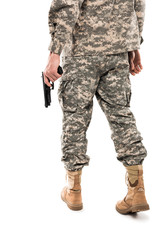 cropped view of man in military uniform holding gun isolated on white