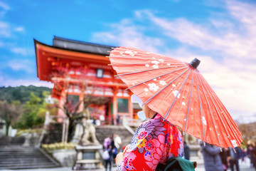 Young japanese woman wearing kimono with umbrella walking in Kyoto, Japan.