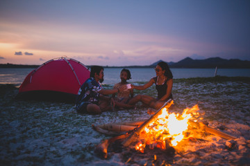 fire in fireplace family camping on the beach 