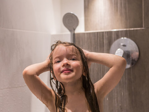 Smiling Little Girl Under The Shower