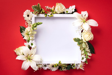 Frame of white flowers over red background. Valentines day, Woman day concept. Spring or summer banner with copy space