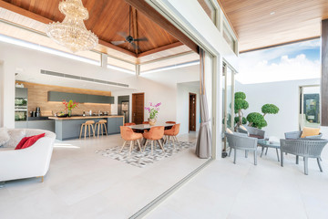 interior design in living room and open kitchen area with dining table