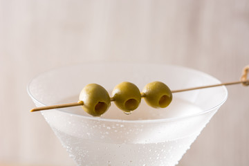 Classic Dry Martini with olives on gray background. Close up
