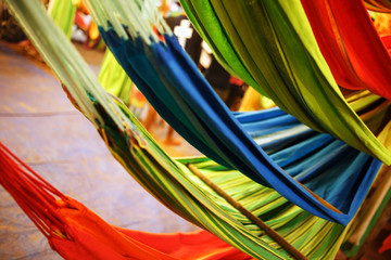 Hammocks of different colors, colors of the rainbow on the night market in Goa