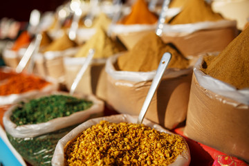 Colorful spices in bags at a market in Goa
