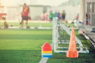 multi color of marker cones and mini goal on green artificial turf for soccer training equipment