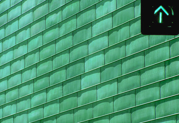 Green Traffic Light in Front of Green Building. Abstract Architecture Background. Colorful Copy Space.
