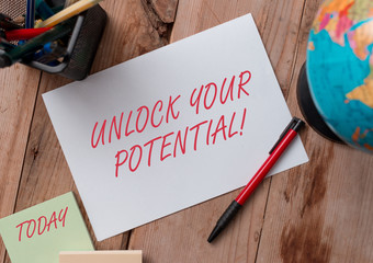 Word writing text Unlock Your Potential. Business photo showcasing release possibilities Education and good training is key Writing equipments and sheets with artificial globe on the wooden desk