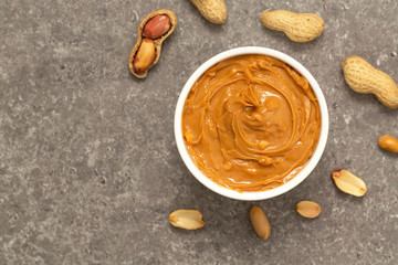 Creamy peanut butter and peanuts. Natural nutrition and organic food. Selective focus. 