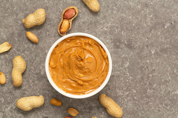 Creamy peanut butter and peanuts. Natural nutrition and organic food. Selective focus. 