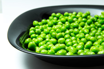 fresh green peas in plate close up